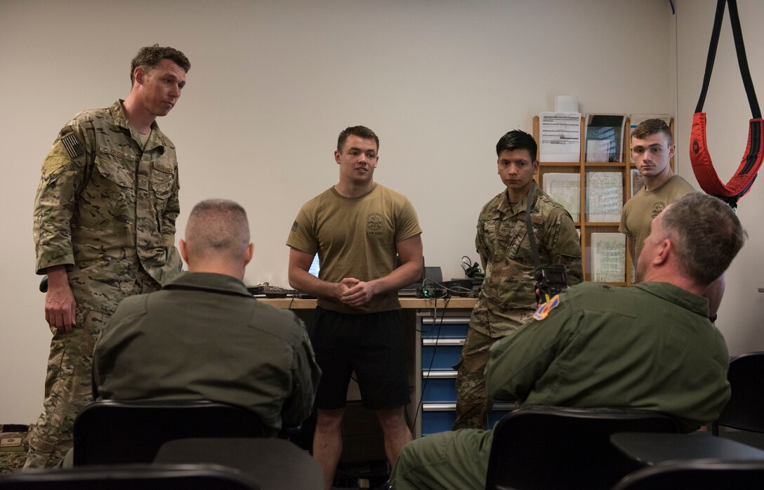 Senior Airman Kenneth Brannan, 4th Equipment Maintenance Squadron aircraft maintenance journeyman, explains a Portable Terminal Area Communication Interrogation Unit, or PTIU, to Col Brian Montgomery, Deployable Air Operations Centre director, left, and Brig. Gen. Mark Slocum, Air Combat Command Inspector General, right, March 26, 2019, at Seymour Johnson Air Force Base, North Carolina. The PTIU is used to communicate with downed aircrew, and can send and receive text messages and coordinates during combat and water survival training and in real life scenarios. (U.S. Air Force photo by Senior Airman Kenneth Boyton)