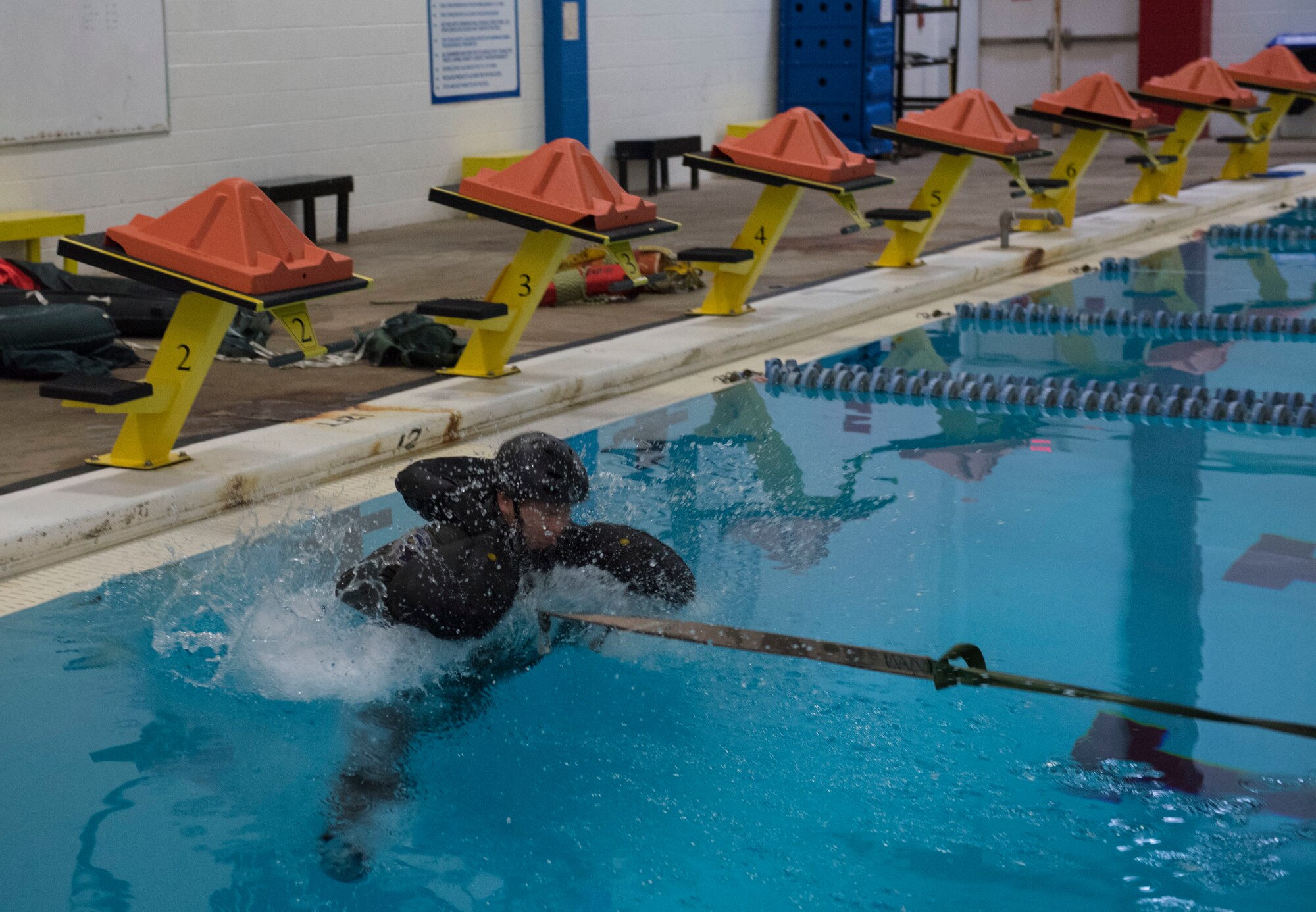Airman 1st Class Joel Mier, 4th Component Maintenance Squadron aircraft fuel systems journeyman, demonstrates a training exercise during water survival training, March 26, 2019, at the Goldsboro YMCA, North Carolina. Mier, a survival, evasion, resistance and escape augmentee, simulated an aircrew member being dragged by a parachute while in the water, who must detach himself before they drown. (U.S. Air Force photo by Senior Airman Kenneth Boyton)