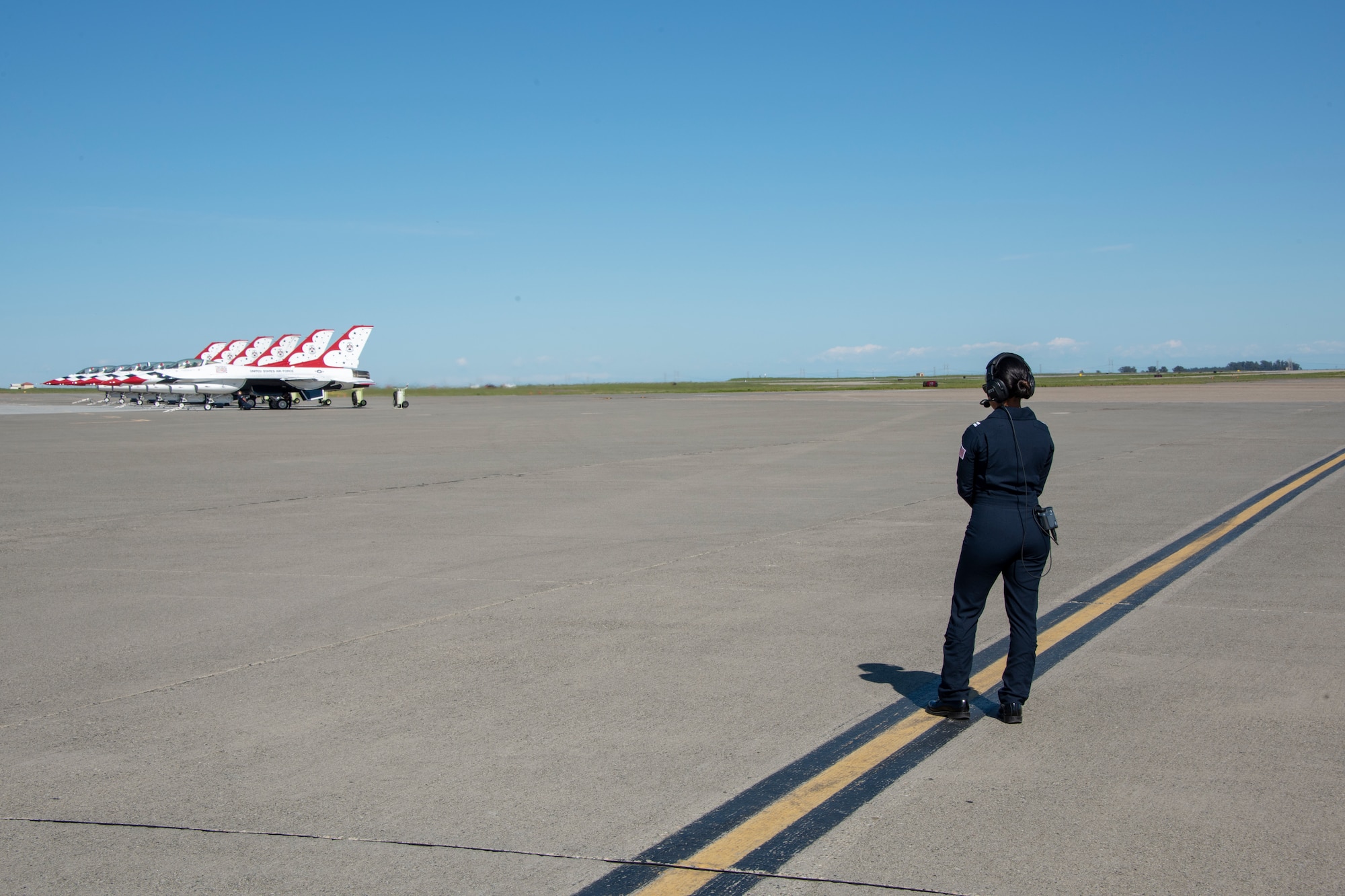 U.S. Air Force Thunderbirds maintenance officer Capt. Kassandra Mangosing watches as the U.S. Air Force Thunderbirds prepare to launch at the “Thunder Over the Bay” Air Show at Travis Air Force Base, California, March 30, 2019. The two-day event featured performances by the U.S. Air Force Thunderbirds aerial demonstration team, U.S. Army Golden Knights parachute team, flyovers, and static displays. The event honored hometown heroes like police officers, firefighters, nurses, teachers and ordinary citizens whose selfless work made their communities safer and enhanced the quality of life. (U.S. Air Force photo by Heide Couch)