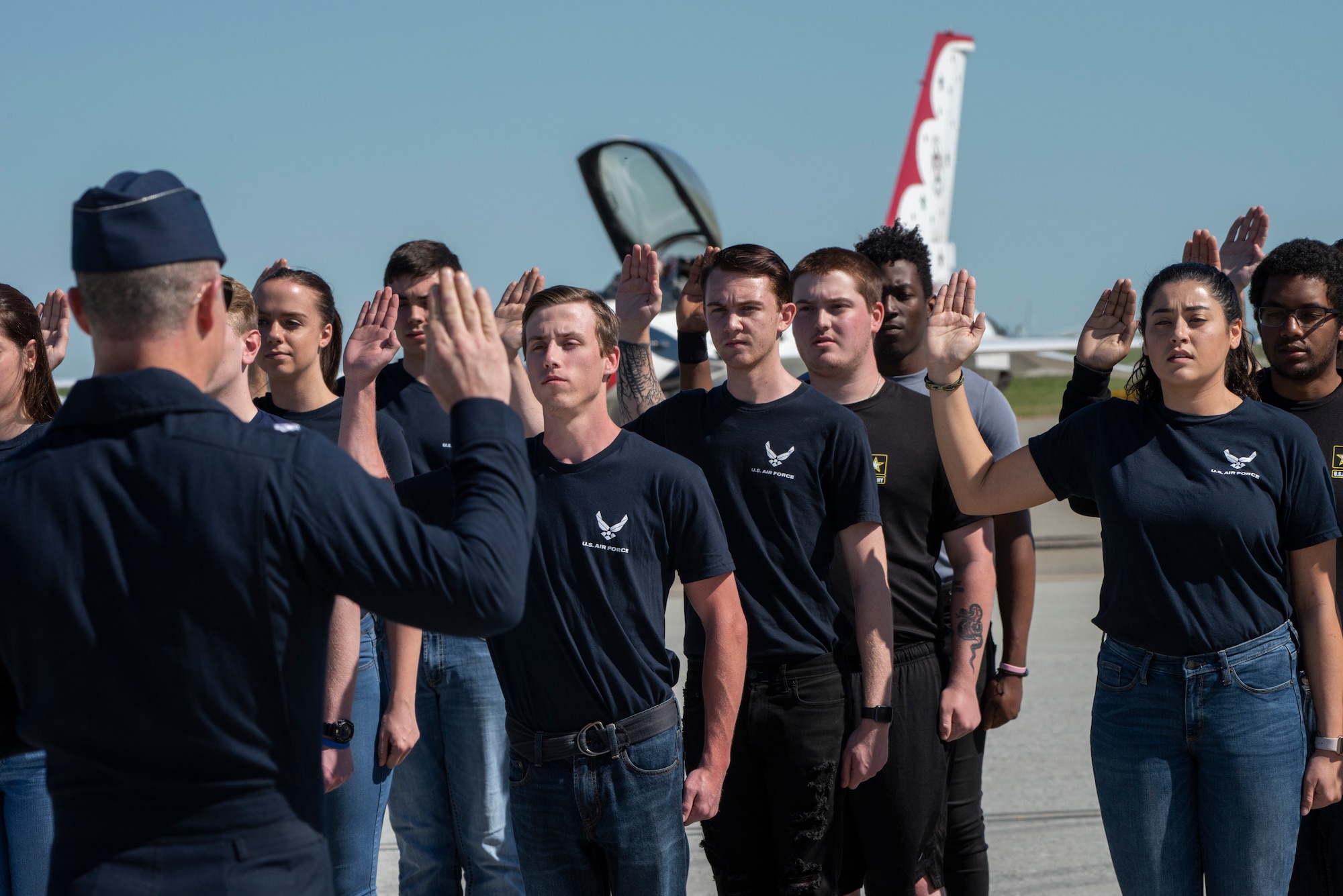 U.S. Air Force Thunderbirds commander Lt. Col. John Caldwell administers the oath of enlistment to new U. S. Air Force and Army enlistees at the “Thunder Over the Bay” Air Show at Travis Air Force Base, California, March 30, 2019. The two-day event featured performances by the U.S. Air Force Thunderbirds aerial demonstration team, U.S. Army Golden Knights parachute team, flyovers, and static displays. The event honored hometown heroes like police officers, firefighters, nurses, teachers and ordinary citizens whose selfless work made their communities safer and enhanced the quality of life. (U.S. Air Force photo by Heide Couch)