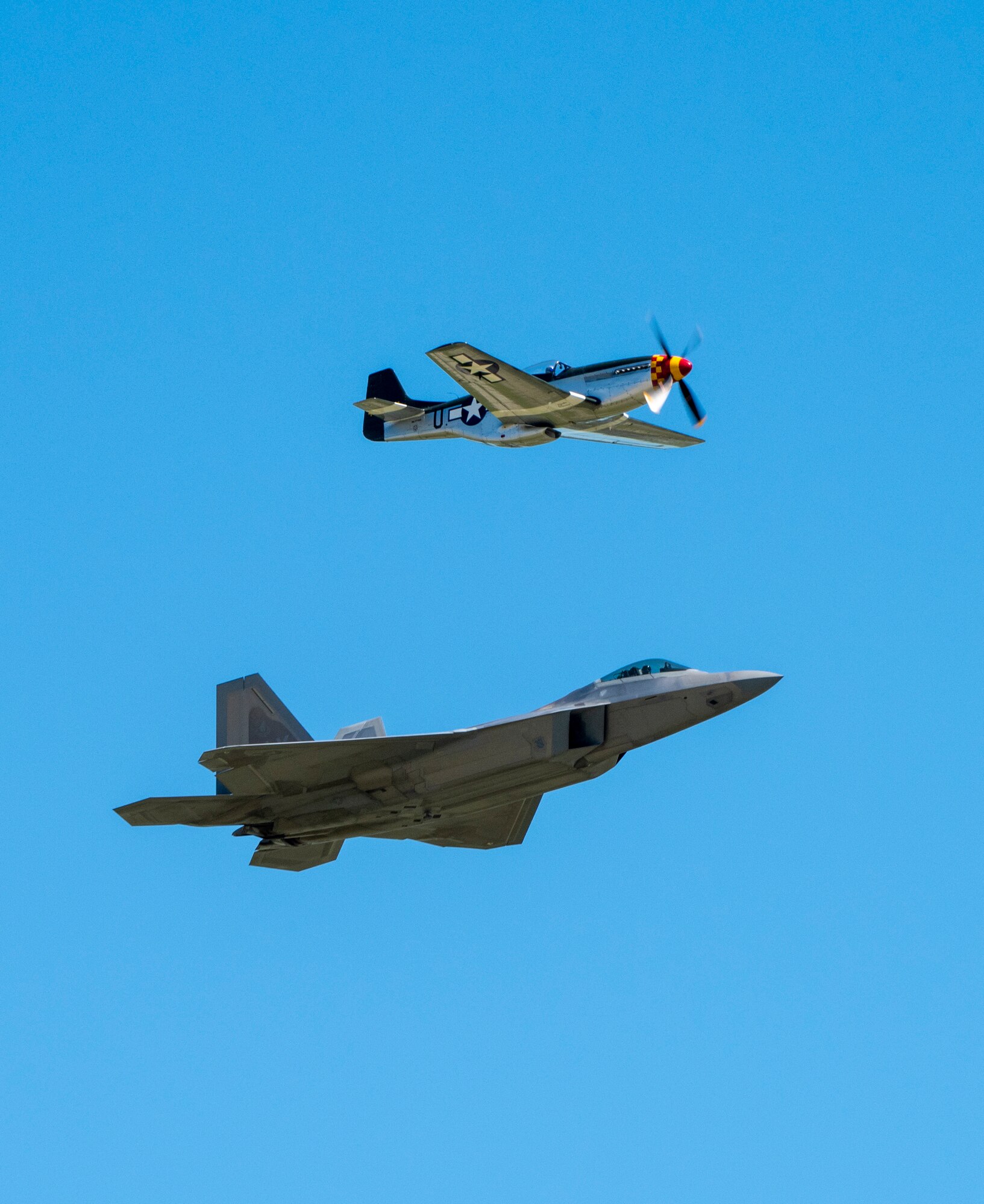 A U.S. Air Force F-22 Raptor and a North American P-51 Mustang perform the heritage flight during the “Thunder Over the Bay” Air Show at Travis Air Force Base, California, March 30, 2019. In addition to the F-22 Raptor, the two-day event featured performances by the U.S. Air Force Thunderbirds aerial demonstration team, U.S. Army Golden Knights parachute team, flyovers, and static displays. The event honored hometown heroes like police officers, firefighters, nurses, teachers and ordinary citizens whose selfless work made their communities safer and enhanced the quality of life. (U.S. Air Force photo by Heide Couch)
