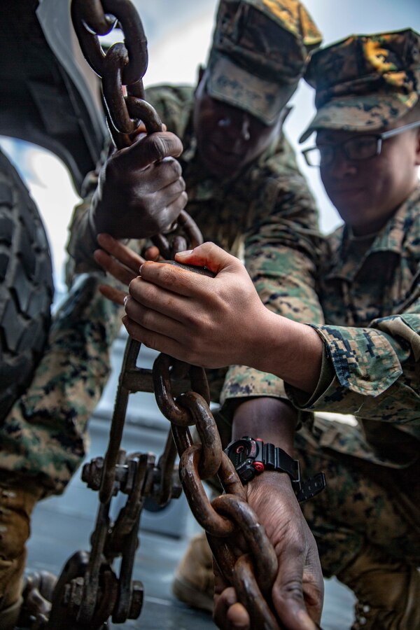 U.S. Marine Corps Lance Cpl. Anthony Boulding, left, a motor transport operator and Lance Cpl. Gabriel Ginn, an embarkations clerk, both with 1st Marine Division, secure a Medium Tactical Vehicle Replacement truck onto a Landing Craft Utility during maritime movement operations at Port Hueneme, Calif., as part of Exercise Pacific Blitz 19, March 12. PacBlitz19 is designed to train Marines and Sailors in maritime prepositioning force operations and aims to increase proficiency, expand levels of cooperation and to enhance maritime capabilities. (U.S. Marine Corps photo by Cpl. Jacob A. Farbo)