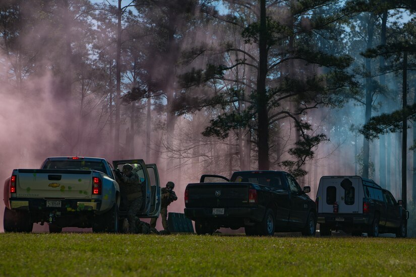 628th Civil Engineer Squadron, Explosive Ordnance Disposal Airmen use their convoy of vehicles as cover while returning fire during combat tactics training March 22, 2019, at Joint Base Charleston, S.C. - Naval Weapons Station.