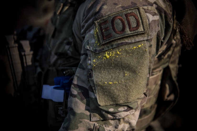 The shoulder of a 628th Civil Engineer Squadron, Explosive Ordnance Disposal flight, Airman covered in paint after a routine training exercise, March 22, 2019, at a training compound on the Joint Base Charleston, S.C. - Naval Weapons Station.