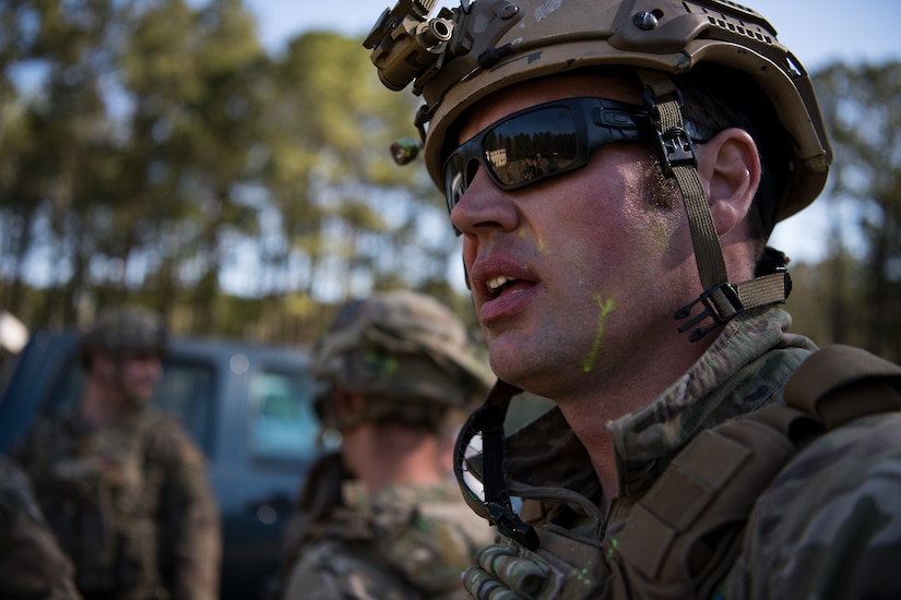 A 628th Explosive Ordnance Disposal Airman speaks to his team members after the conclusion of combat tactics training March 22, 2019, at Joint Base Charleston, S.C.
