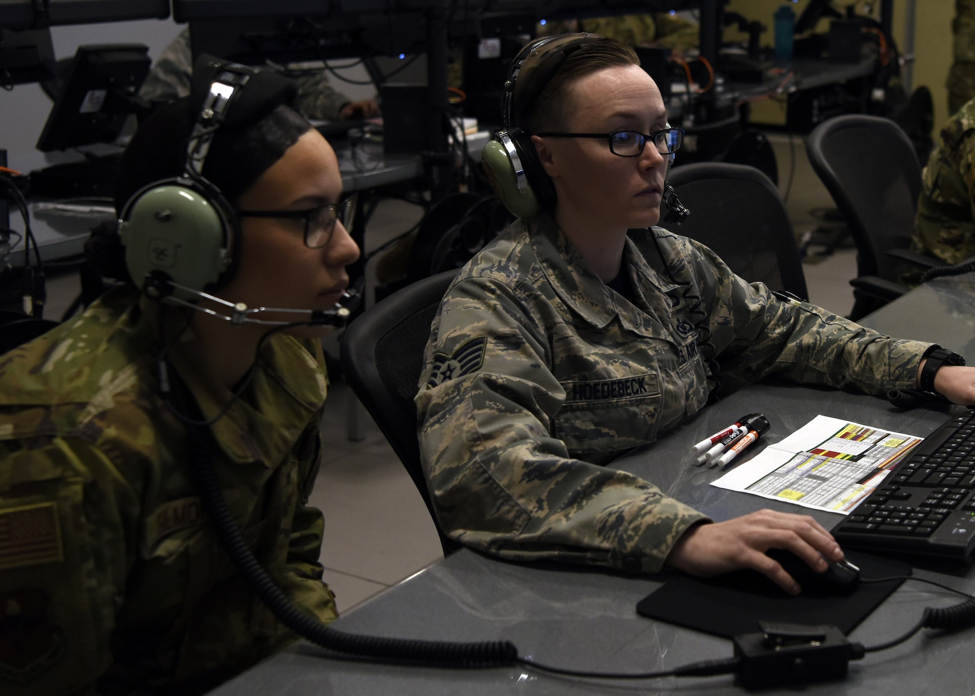 Staff Sgt. Amber Hoedebeck, 607th Air Control Squadron Weapons Director Initial Qualification Training course manager, controls an air fight as Amn Jaeda Gilmore, 607 ACS trainee, simulates friendly fire during the first all-female Command and Control Battle Management Operations team mission March 22, 2019, at Luke Air Force Base, Ariz. From scheduling and mission planning to communications equipment set up and maintenance, they left their mark on history as the first crew of all women. (U.S. Air Force photo by Airman 1st Class Zoie Cox)