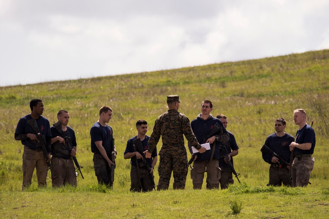 U.S. Marine Corps 2nd Lt. Enrique Torresvargas (center), a recently commissioned lieutenant with Officer Selection Team San Jose, Officer Selection Office San Jose, teaches candidates and applicants about fireteam tactics during a Mini Officer Candidate School at U.S. Army Reserve Camp Parks in Dublin, Calif., March 23, 2019. Mini OCS is designed to give candidates and applicants an idea of what to expect at Marine Corps Officer Candidate School. (U.S. Marine Corps photo by Sgt. Christian Cachola)