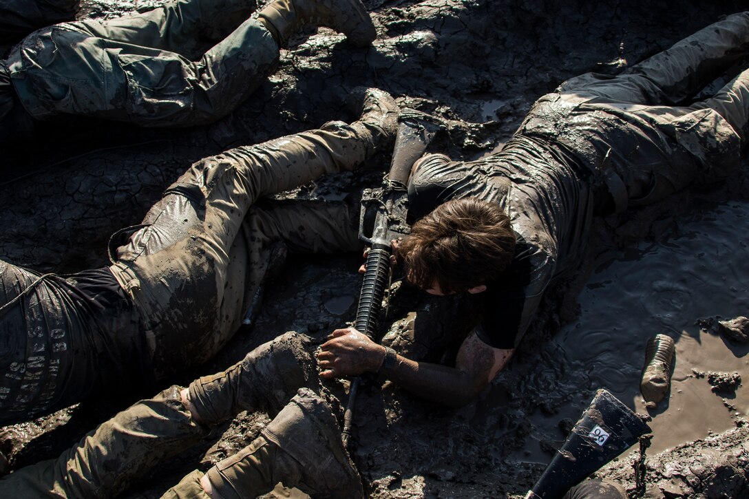 U.S. Marine Corps Officer candidates with Officer Selection Office San Jose crawl through mud during a Mini Officer Candidate School at U.S. Army Reserve Camp Parks in Dublin, Calif., March 23, 2019. Mini OCS is designed to give candidates and applicants an idea of what to expect at Marine Corps Officer Candidate School. (U.S. Marine Corps photo by Sgt. Christian Cachola)