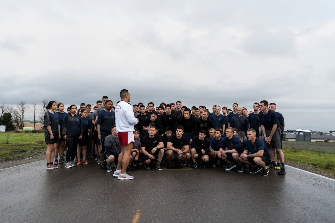 U.S. Marine Corps Gunnery Sgt. Juan Aguilera (center left), a Physical Training Instructor with U.S. Marine Corps Officer Candidate School, briefs the 3-mile run route to candidates and applicants during a Mini OCS at U.S. Army Reserve Camp Parks in Dublin, Calif., March 23, 2019. Mini OCS is designed to give candidates and applicants an idea of what to expect at Marine Corps Officer Candidate School. (U.S. Marine Corps photo by Sgt. Christian Cachola)