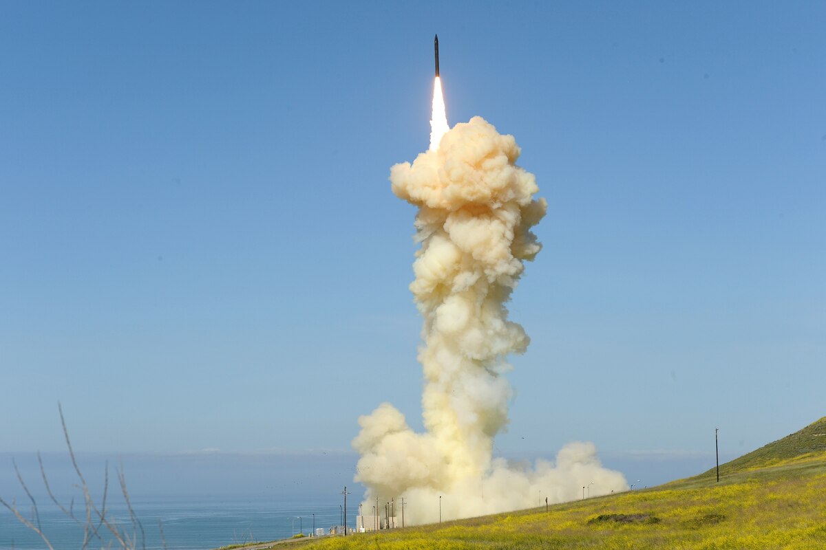 A missile interceptor launches amid an ignition cloud.