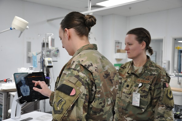 Emergency room nurse Capt. Katie Barnack and trauma surgeon Lt. Col. (Dr.) Valerie Sams, currently deployed to the 455th Expeditionary Medical Group at Bagram Airfield, Afghanistan, demonstrate the T6 Health System, which is in trial phase at the Craig Joint Theater Hospital.