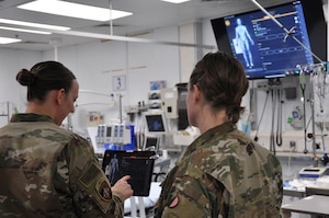Emergency room nurse Capt. Katie Barnack and trauma surgeon Lt. Col. (Dr.) Valerie Sams, currently deployed to the 455th Expeditionary Medical Group at Bagram Airfield, Afghanistan, demonstrate the T6 Health System, which is in trial phase at the Craig Joint Theater Hospital.