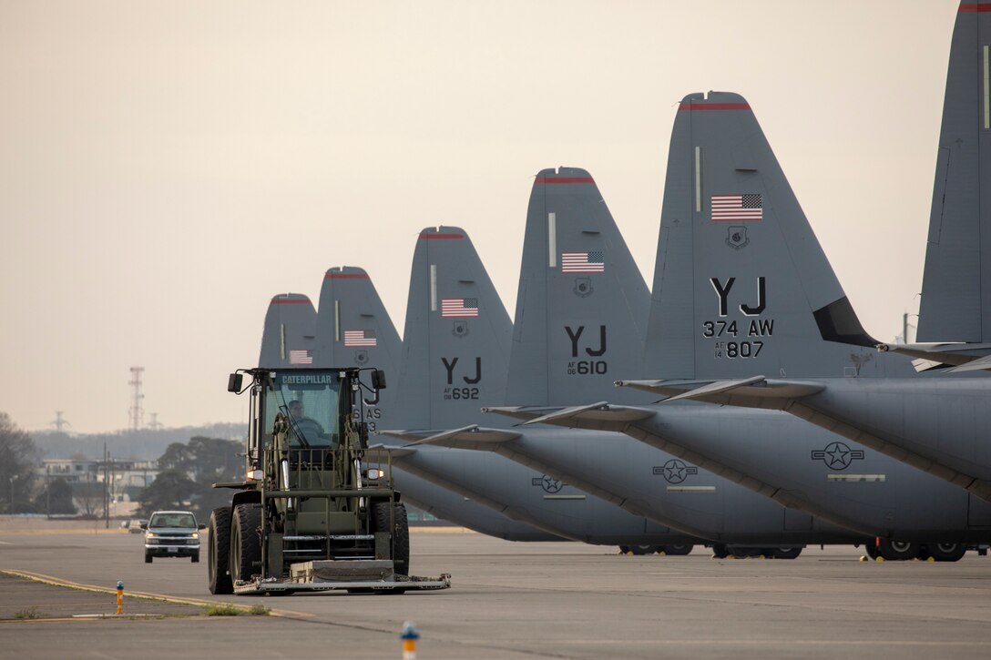 wait to loading a pallet onto a C-130J Super Hercules