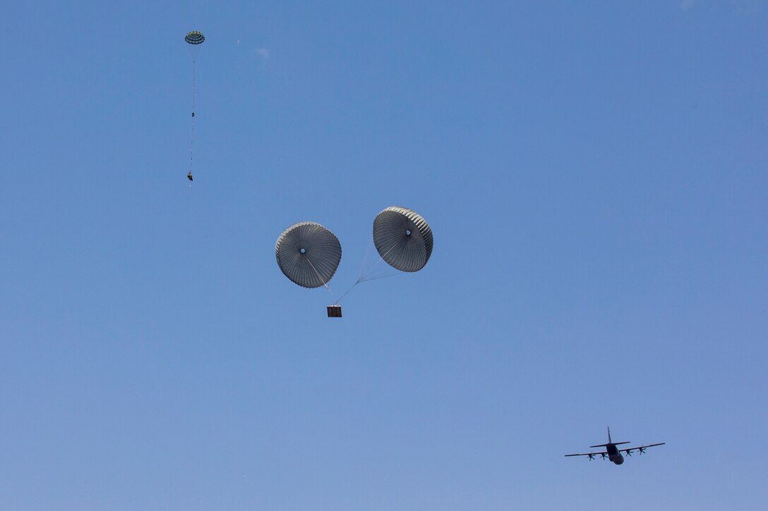 Parachutes open as a bundle floats