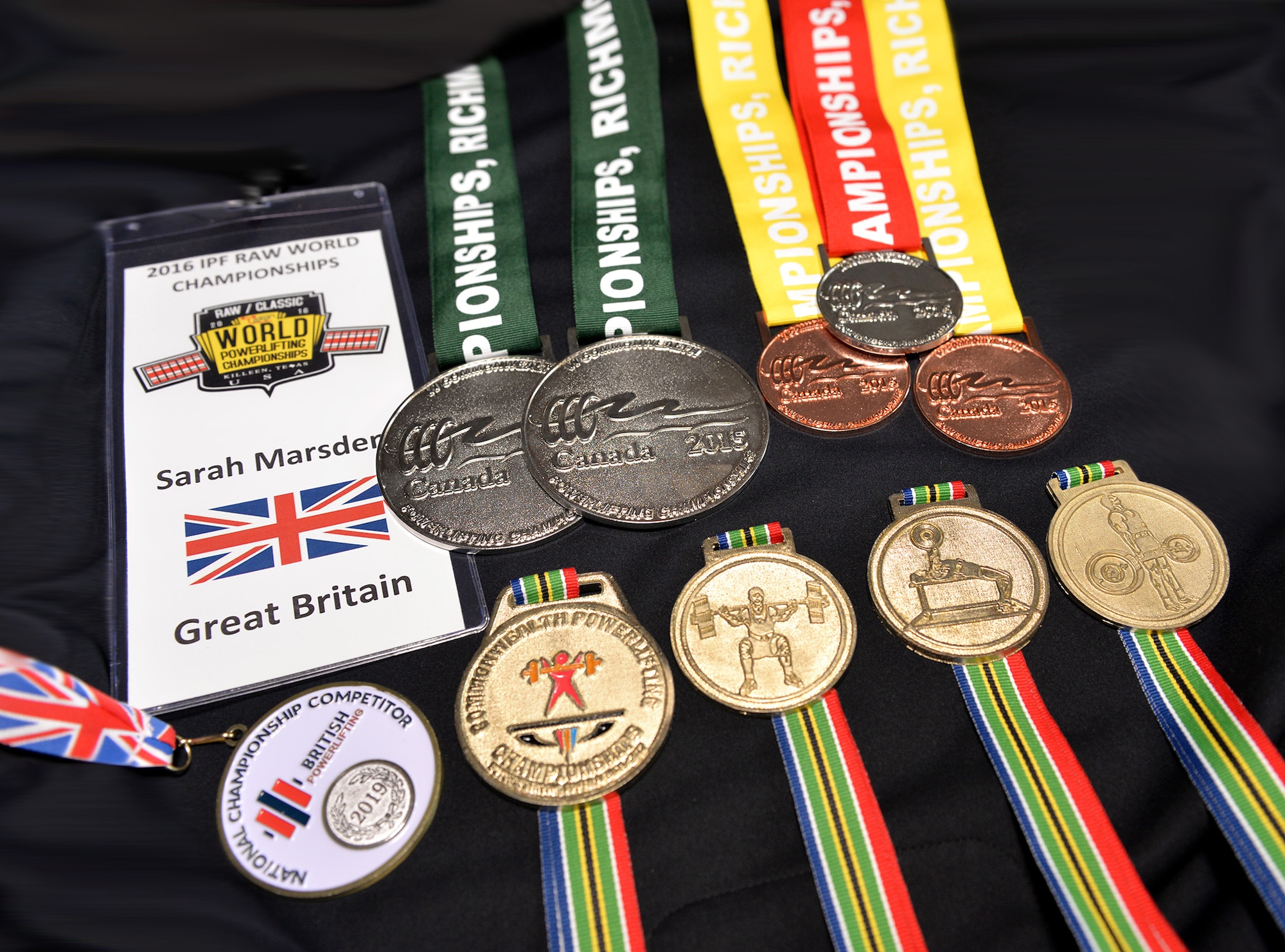 Gold, silver and bronze medals from powerlifting competitions around the world, earned by Sarah Marsden, 100th Civil Engineer Squadron environmental engineer, are displayed at RAF Mildenhall, England, March 19, 2019. Marsden, a self-confessed adrenaline junkie, has previously done sports and activities including motor racing, karate, hockey and sky diving. She is now a world champion powerlifter and has earned medals in competitions all around the world. (U.S. Air Force photo by Karen Abeyasekere)