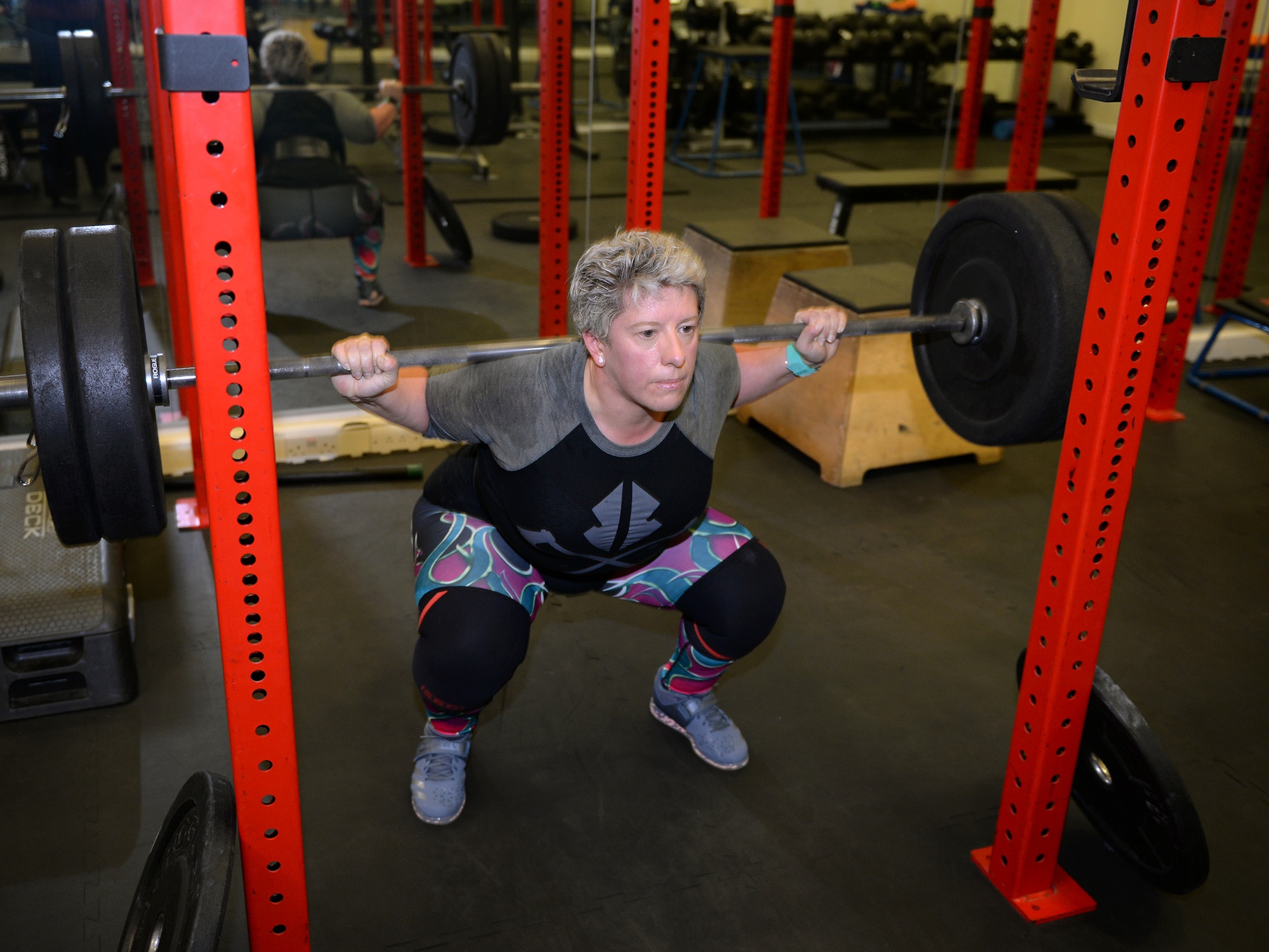 Sarah Marsden, 100th Civil Engineer Squadron environmental engineer, performs a squat during a workout session on RAF Mildenhall, England, March 26, 2019. Marsden is a champion powerlifter, and has earned medals from British, European and World Championships. (U.S. Air Force photo by Karen Abeyasekere)