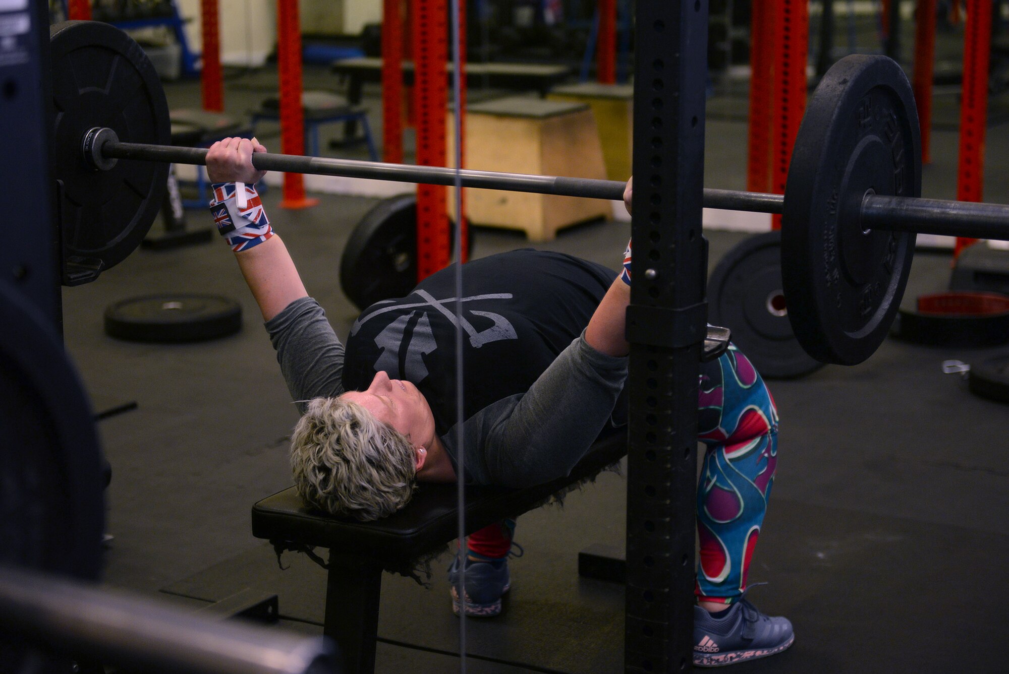 Sarah Marsden, 100th Civil Engineer Squadron environmental engineer, performs a bench press with some light weights during a workout session on RAF Mildenhall, England, March 26, 2019. Marsden is a champion powerlifter, and has earned medals from British, European and World Championships. (U.S. Air Force photo by Karen Abeyasekere)