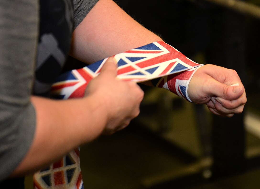 Sarah Marsden, 100th Civil Engineer Squadron environmental engineer and British civilian, puts on wrist wraps during a bench press workout session at RAF Mildenhall, England, March 26, 2019. Marsden is a champion powerlifter, and has earned medals from British, European and World Championships. (U.S. Air Force photo by Karen Abeyasekere)
