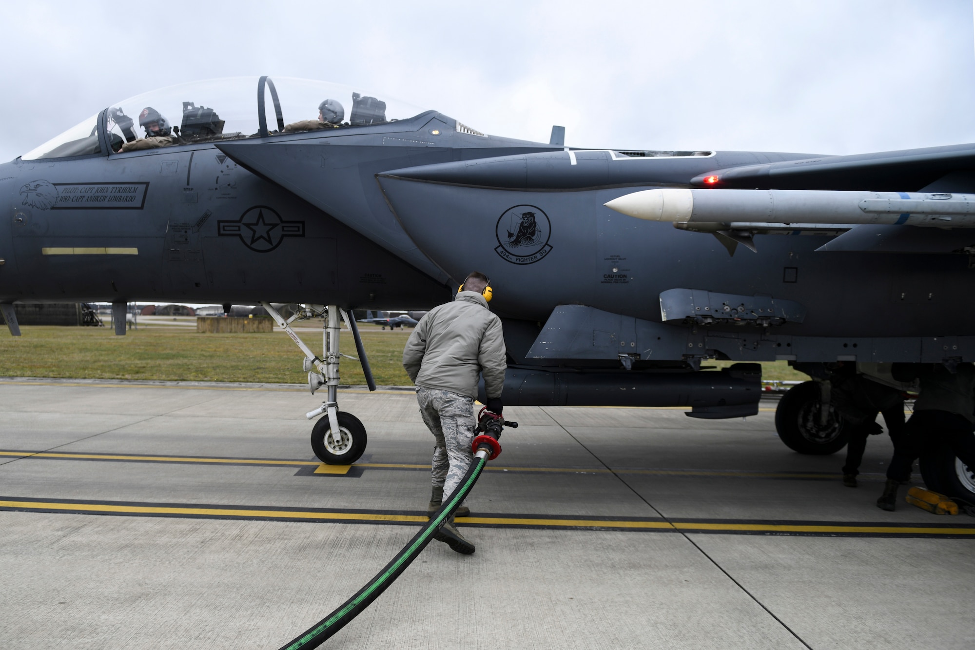 A 48th Logistics Readiness Squadron Fuels Distribution operator prepares to attach a fuel hose to an F-15E Strike Eagle assigned to the 494th Fighter Squadron at Royal Air Force Lakenheath, England, March 12, 2019. The 48th LRS has integrated an Isometric R-11 Refueling Truck into refueling operations to improve squadron capabilities. (U.S. Air Force photo by Senior Airman Malcolm Mayfield)