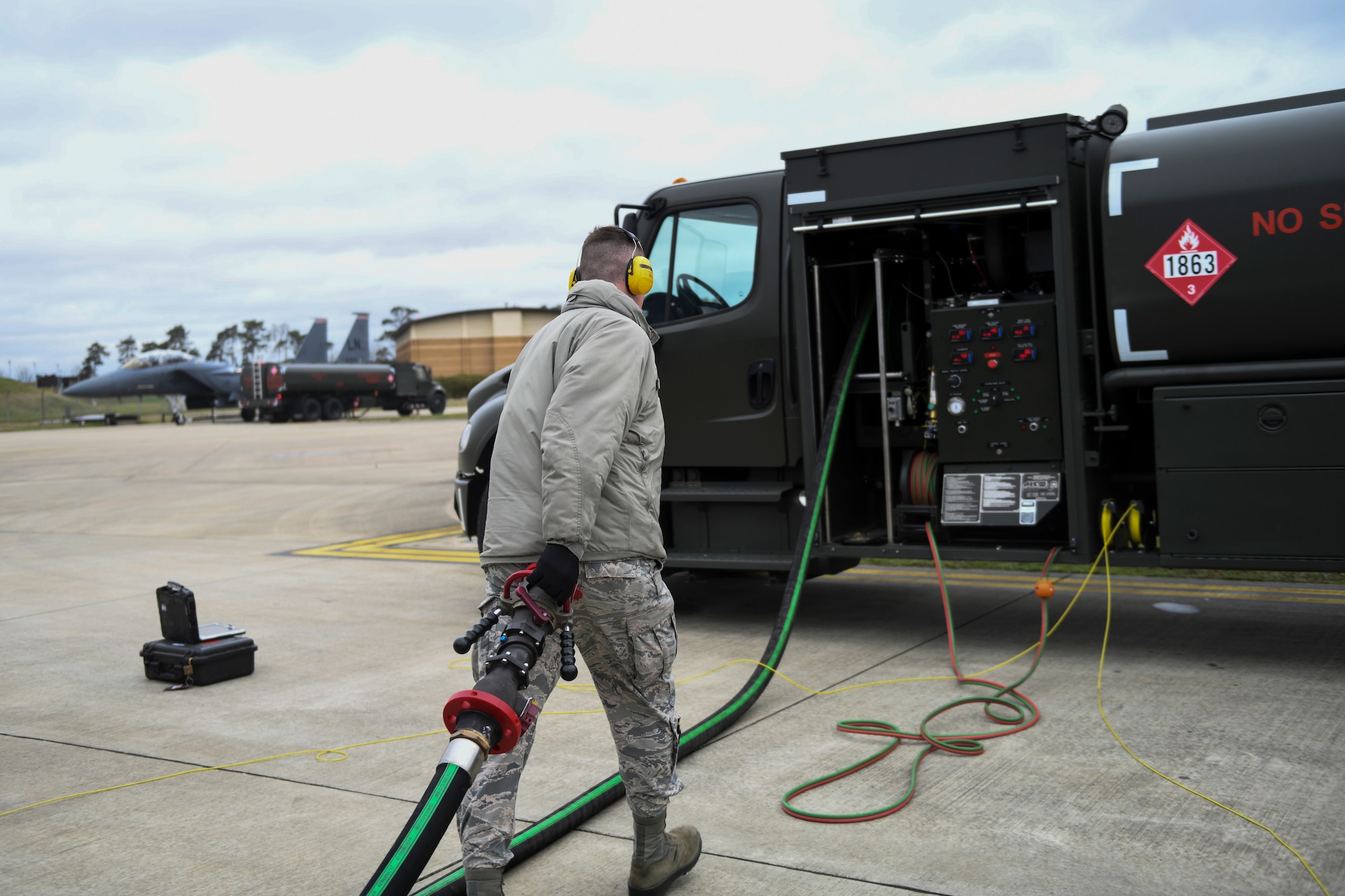 A 48th Logistics Readiness Squadron Fuels Distribution operator returns a fuel hose to an Isometric R-11 Refueling Truck at Royal Air Force Lakenheath, England, March 12, 2019. The vehicles improve the capabilities of the 48th LRS with advanced safety features and up-to-date hardware. (U.S. Air Force photo by Senior Airman Malcolm Mayfield)