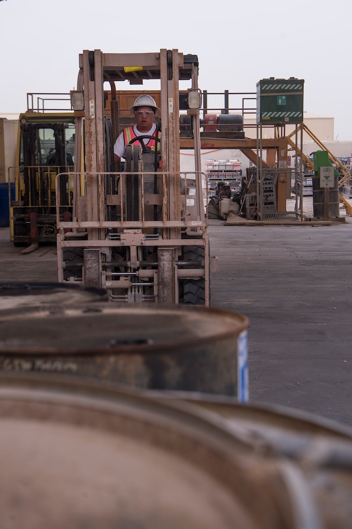 Ramon Gonzales, 379th Expeditionary Civil Engineer Squadron (ECES) environmental technician, uses a forklift to transport equipment needed to ventilate oil drums March 26, 2019, at Al Udeid Air Base, Qatar. The ECES environmental team ensures Airmen on base are able to safely handle hazardous material (HAZMAT) in an environmentally friendly manner. (U.S. Air Force photo by Tech. Sgt. Christopher Hubenthal)