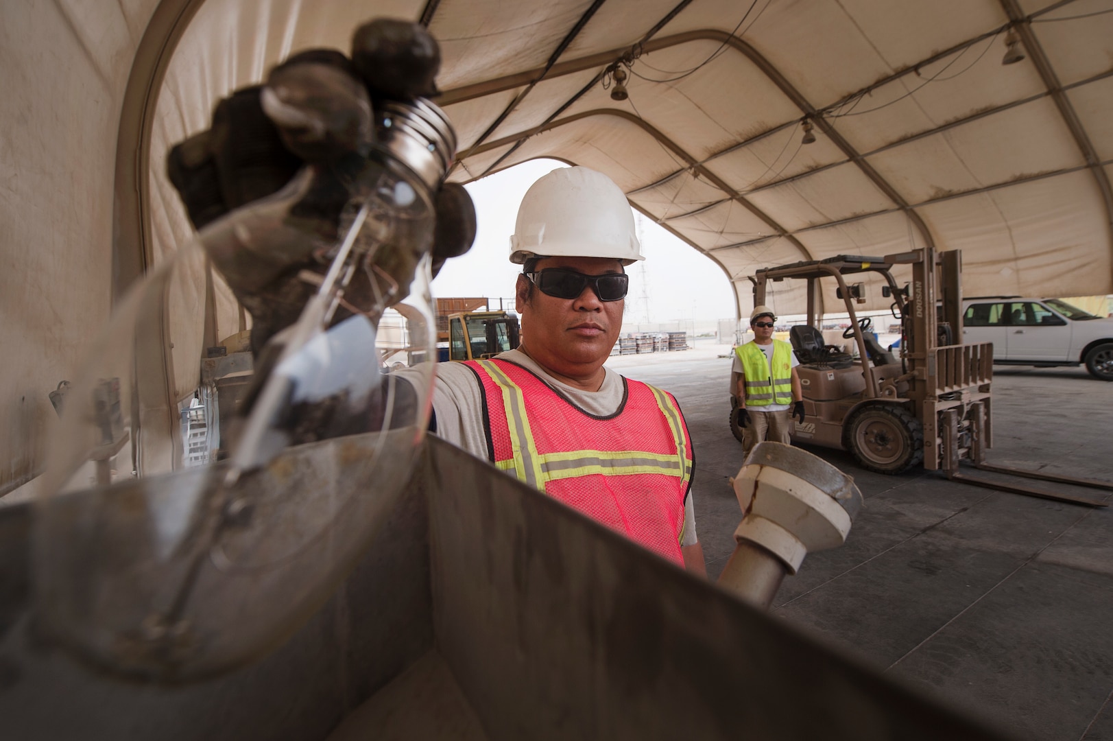 Marino Menor, 379th Expeditionary Civil Engineer Squadron (ECES) lead environmental technician, breaks down fluorescent bulbs for recycling March 26, 2019, at Al Udeid Air Base, Qatar. The ECES environmental team ensures Airmen on base are able to safely handle hazardous material (HAZMAT) in an environmentally friendly manner. (U.S. Air Force photo by Tech. Sgt. Christopher Hubenthal)