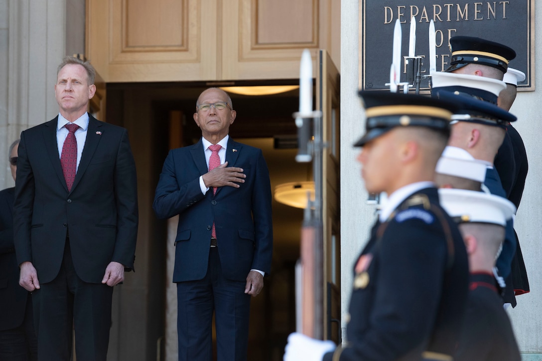 Two defense leaders stand next to each other outside the Pentagon.