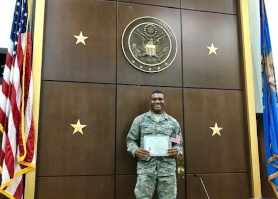 Airman 1st Class Godspower Igben, 507th Force Support Squadron food operations specialist, stands for a photograph with his U.S. citizenship certificate in an Oklahoma City courthouse Feb. 22, 2019.  Igben was raised in Lagos, Nigeria, and moved to the U.S. when he was 22 years old. Igben's family members served in the Nigerian military, inspiring him to join the U.S. Air Force Reserve. Wingmen within his unit attended the citizenship ceremony in a show of support as Igben became a U.S. citizen. (U.S. Air Force photo by Master Sgt. Melissa Childers)