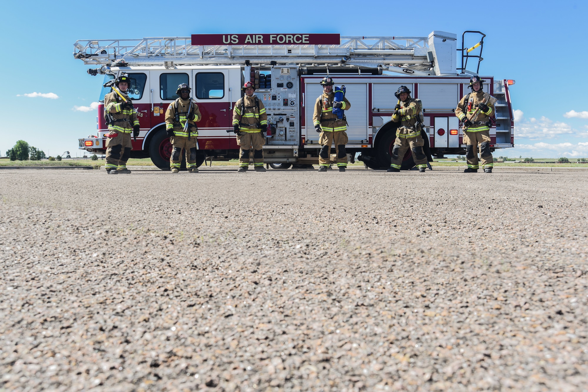 Airmen from the F.E. Warren Fire and Emergency Services gear up for training with fire resistant clothing, oxygen tanks and fire axes, June 18, 2018 at F.E. Warren Air Force Base, Wyo. In 2010 the F.E. Warren fire department began the Commission on Fire Accreditation International accreditation process and first achieved it in 2014. (U.S. Air Force photo by Airman 1st Class Abbigayle Williams)