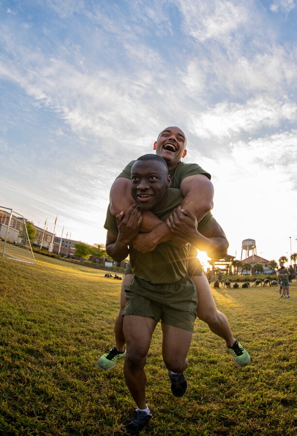 Cpl. Roshard Gordon, an administrative chief with G-6, Marine Forces Reserve, carries a Marine at Marine Corps Support Facility New Orleans, March 29, 2019, during a Total Force Fitness event. The MARFORRES Marines conducted various physical activities, such as tug-of-war, buddy carries, high-intensity suicide drills, medicine ball exercises and the dissemble and assembly of a M4 Service Carbine. The event promoted physical fitness, unit cohesion and esprit de corps. (U.S. Marine Corps photo by Sgt. Andy O. Martinez)