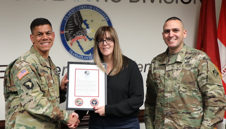 Transatlantic Division Commander Col. Mark C. Quander (left) and Command Sergeant Major Randolph Delapena (right) present the TAD “Employee of the Year” Award for 2018 to Rachael Raposa, TAD’s Regional Contracting Chief, during a ceremony held in Winchester, Va., on March 28, 2019. Quander praised Raposa for her contracting expertise, world-class contracting support, and volunteer spirit.