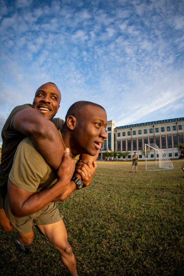 Cpl. Roshard Gordon, an administrative chief with G-6, Marine Forces Reserve, carries a Marine at Marine Corps Support Facility New Orleans, March 29, 2019, during a Total Force Fitness event. The MARFORRES Marines conducted various physical activities, such as tug-of-war, buddy carries, high-intensity suicide drills, medicine ball exercises and the dissemble and assembly of a M4 Service Carbine. The event promoted physical fitness, unit cohesion and esprit de corps. (U.S. Marine Corps photo by Sgt. Andy O. Martinez)