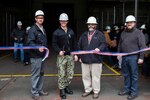 Norfolk Naval Shipyard 's (NNSY) Code 377 Deputy Project Superintendent Jim Brewer, NNSY Shipyard Commander Capt. Kai Torkelson, NNSY's Code 920 Deputy Superintendent John Peters, and NNSY's Code 900P NNSY Lead for Implementation of the Job Readiness Cell  Rob Bogle cut the ribbon for the new Point of Use.