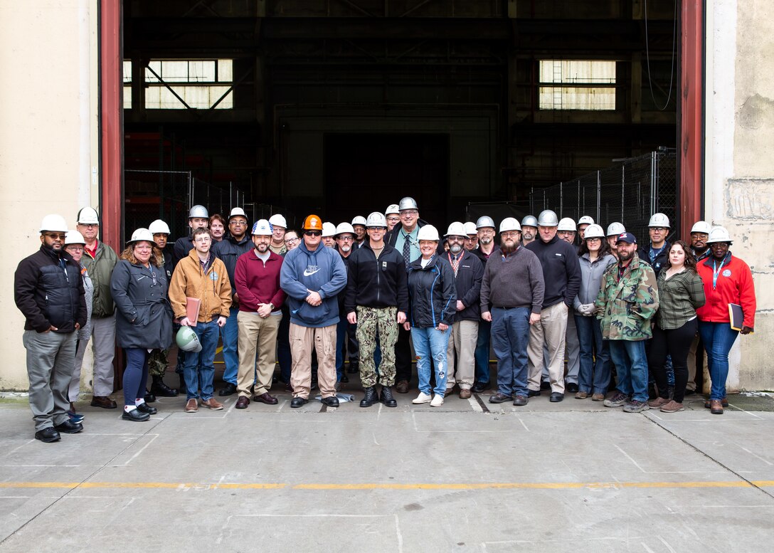 Attendees of the Bldg. 369 Point of Use Ribbon Cutting Ceremony pose for a group photo March 8.