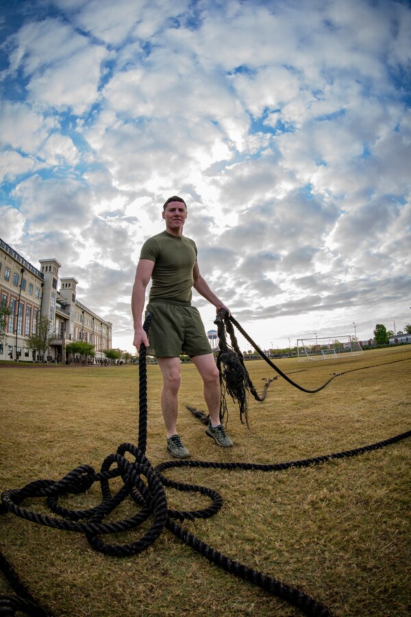 Sgt. Xavier S. Ham, a motor transport dispatcher with S-4, Headquarters Battalion, Marine Forces Reserve, gathers the tug-of-war ropes at Marine Corps Support Facility New Orleans, March 29, 2019, during a Total Force Fitness event. The MARFORRES Marines conducted various physical activities, such as tug-of-war, buddy carries, high-intensity suicide drills, medicine ball exercises and the dissemble and assembly of a M4 Service Carbine. The event promoted physical fitness, unit cohesion and esprit de corps. (U.S. Marine Corps photo by Sgt. Andy O. Martinez)