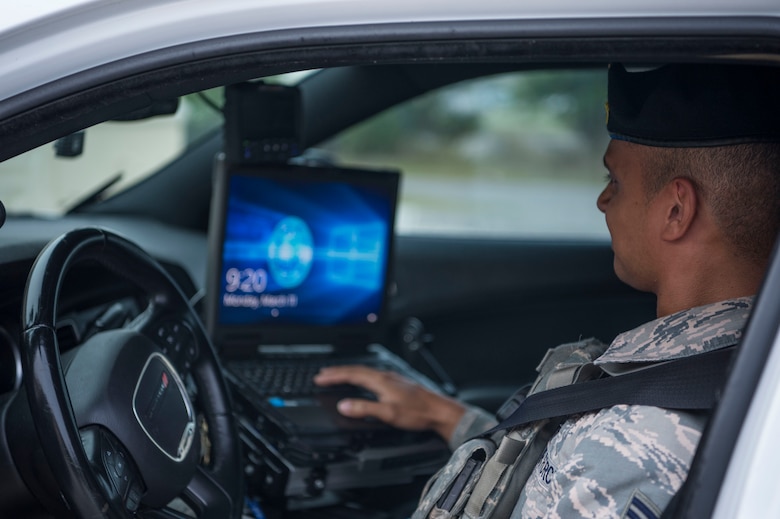 A 6th Security Forces Squadron (SFS) Airman prepares to log in to a laptop inside a patrol vehicle at MacDill Air Force Base, Fla., March 11, 2019.