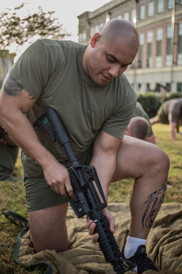 A Marine with Marine Forces Reserve, disassembles a M16 service rifle during a Total Force Fitness event at Marine Corps Support Facility New Orleans, March 29, 2019. The purpose of the event was to boost unit cohesion, morale and maintain high physical fitness standards. (U.S. Marine Corps photo by Sgt. Dante J. Fries)
