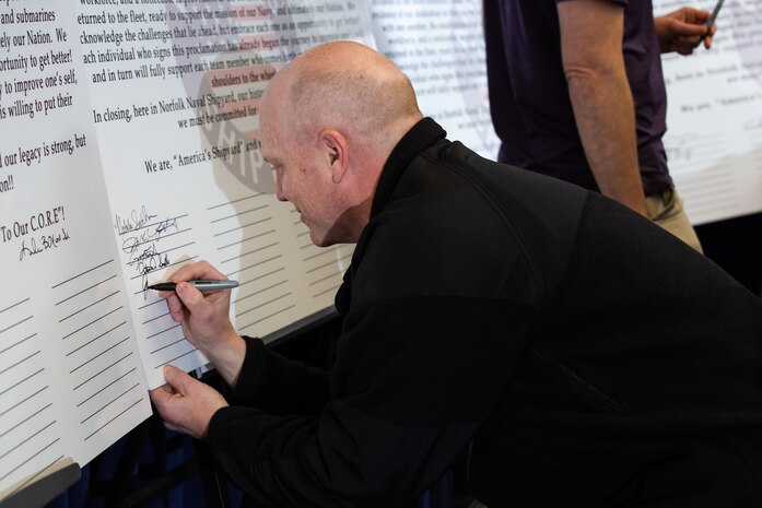 Captain James "Jip" Mosman, Norfolk Naval Shipyard's Operations Officer, signs the Force Multipliers declaration.