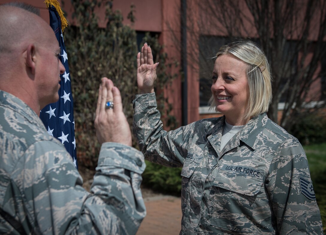 Tech. Sgt. Nikki Seibel, Air Force Reserve Recruiting, recites the Oath of Enlistment given by Lt. Col. Stan Paregien, 932nd Airlift Wing Public Affairs officer, April 1, 2019, Scott Air Force Base, Illinois.  Seibel will begin her next chapter in her Air Force story with a move to Boston to continue her role as an Air Force Reserve recruiter. “I’ve enlisted over 150 Citizen Airmen in the last four years and can’t wait to change more lives,” said Seibel. (U.S. Air Force photo by Christopher Parr)