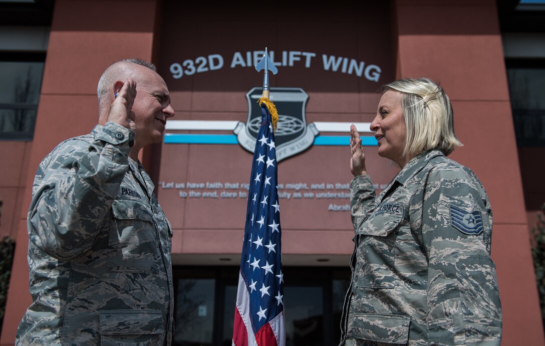 Tech. Sgt. Nikki Seibel, Air Force Reserve Recruiting, recites the Oath of Enlistment given by Lt. Col. Stan Paregien, 932nd Airlift Wing Public Affairs officer, during a sunny afternoon ceremony, April 1, 2019, 932nd AW Headquarters, Scott Air Force Base, Illinois. Seibel began her Air Force journey 9 years ago as the first female flying crew chief on the C-40C. During that time she travelled to 81 countries and now helps new Reserve Citizen Airmen begin their journeys.  (U.S. Air Force photo by Christopher Parr)
