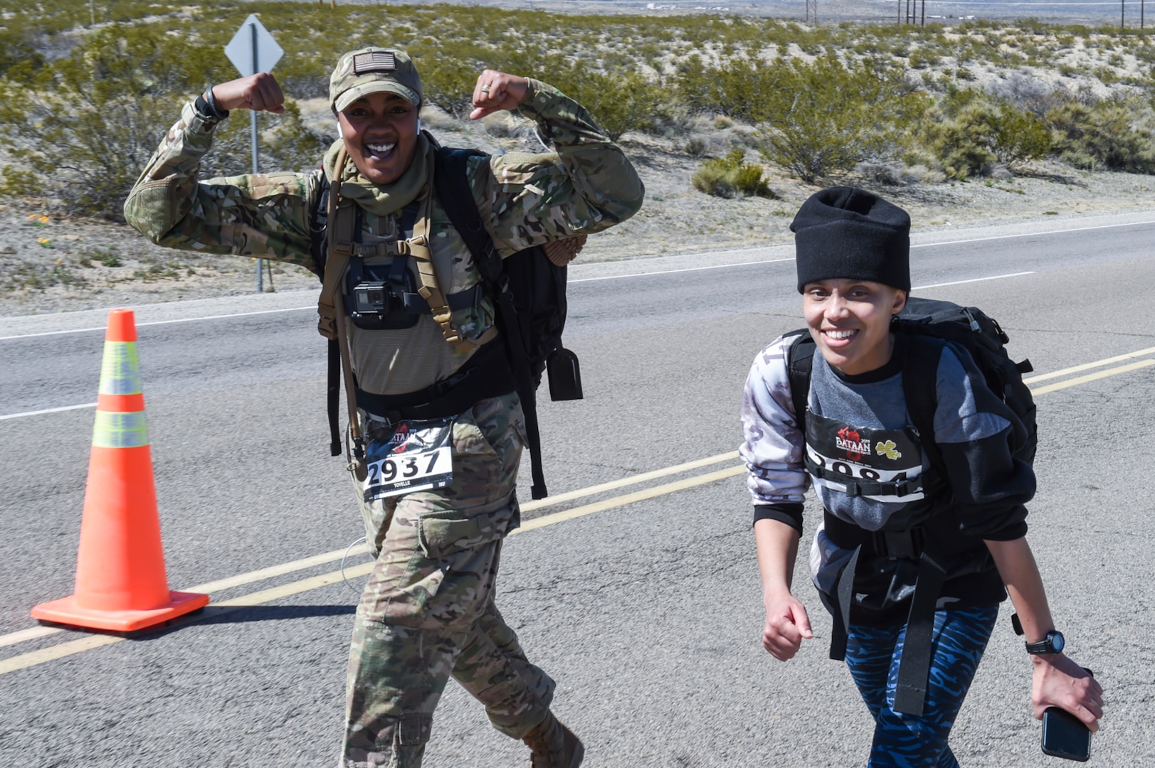 Even after marching 18.5 miles, spirits remained high for both Staff Sgt. Toyelle Rickson and Petty Officer 1st Class Aretha Carmouche during the Bataan Memorial Death March, in White Sands, New Mexico, March 17, 2019.
