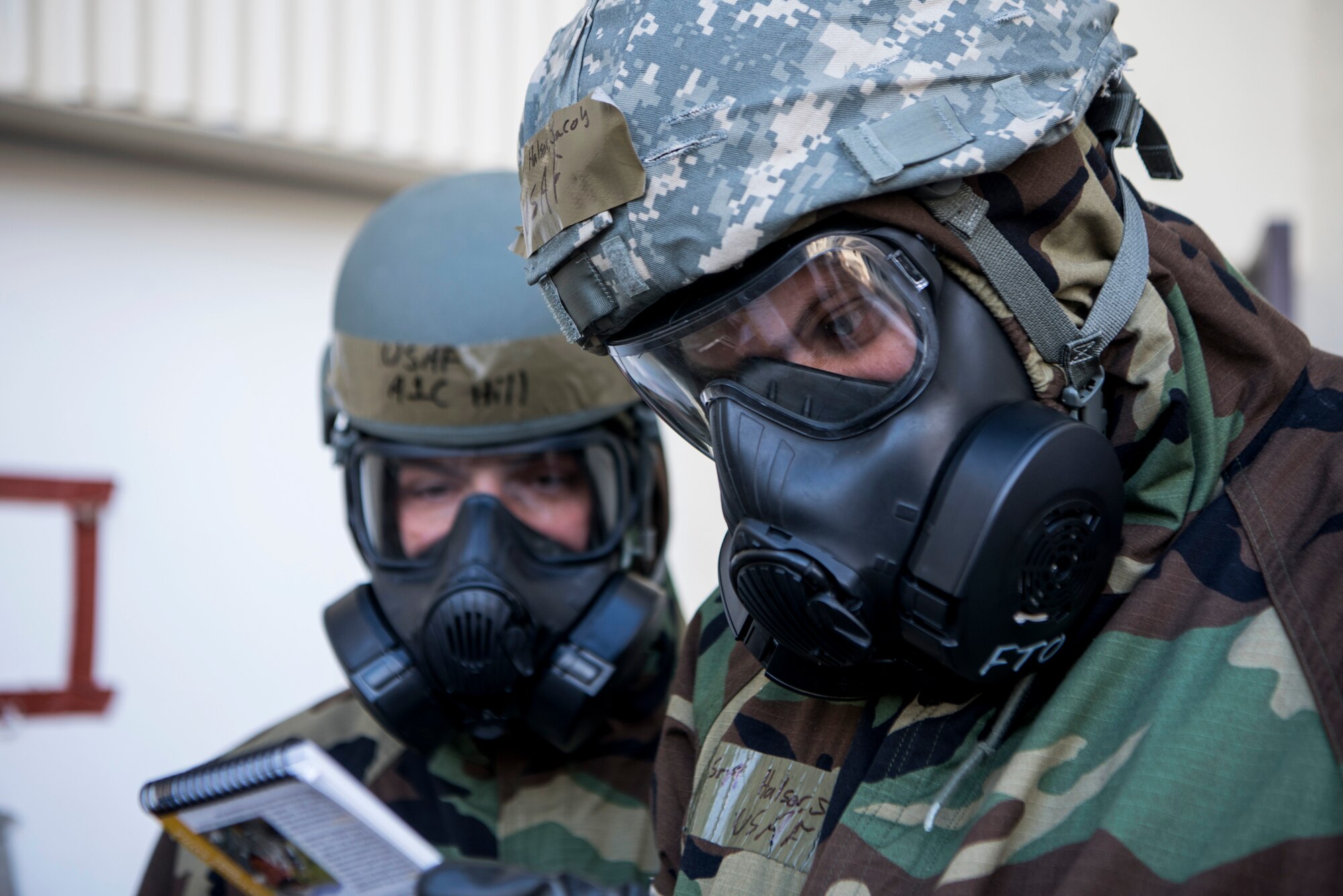 U.S. Air Force Senior Airman Jacob Halson, 673d Contracting Squadron contracting specialist, reads through a checklist while wearing chemical, biological, radiological and nuclear defense gear in a simulated hazardous environment during Polar Force 19-4 at Joint Base Elmendorf-Richardson, Alaska, April 2, 2019. Polar Force is a two-week exercise designed to test JBER’s mission readiness, and develops the skills service members require to face adverse situations.