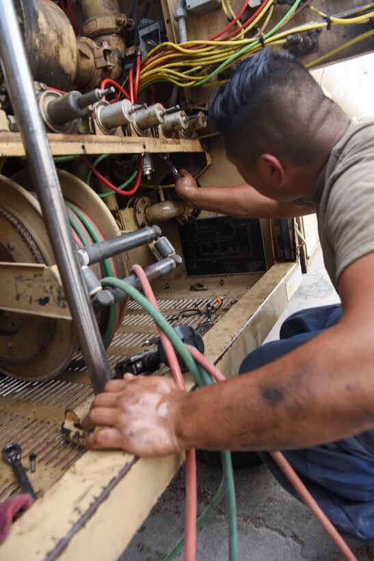 Senior Airman Ismael Garcia, 380th Expeditionary Logistics Readiness Squadron general-purpose mechanic, remove the pilot valve from a refueler truck at Al Dhafra Air Base, United Arab Emirates, Mar. 28, 2019.