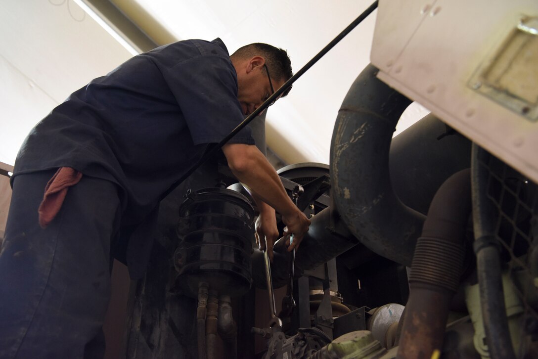 Staff Sgt. Gabriel Villalpando, 380th Expeditionary Logistics Readiness Squadron firetruck and refueling maintenance craftsman, removes the alternator belt from a fire truck at Al Dhafra Air Base, United Arab Emirates, Mar. 28, 2019.