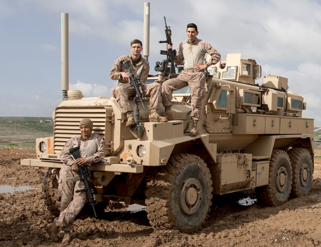 U.S. Marine Corps Sgt. Naomi L. Polumbo, left, Lance Cpl. Jacob Walton, center, motor transport mechanics, and Lance Cpl Edgar Garcia, right, a small arms repairman, all with Combat Logistics Detachment 34, attached to Special Purpose Marine Air-Ground Task Force Crisis Response-Central Command, pose for a photo with a mine resistant, ambush protected vehicle, Southwest Asia, February 10, 2019. As a quick reaction force, the SPMAGTF-CR-CC is capable of deploying aviation, ground and logistical forces forward at a moment’s notice.