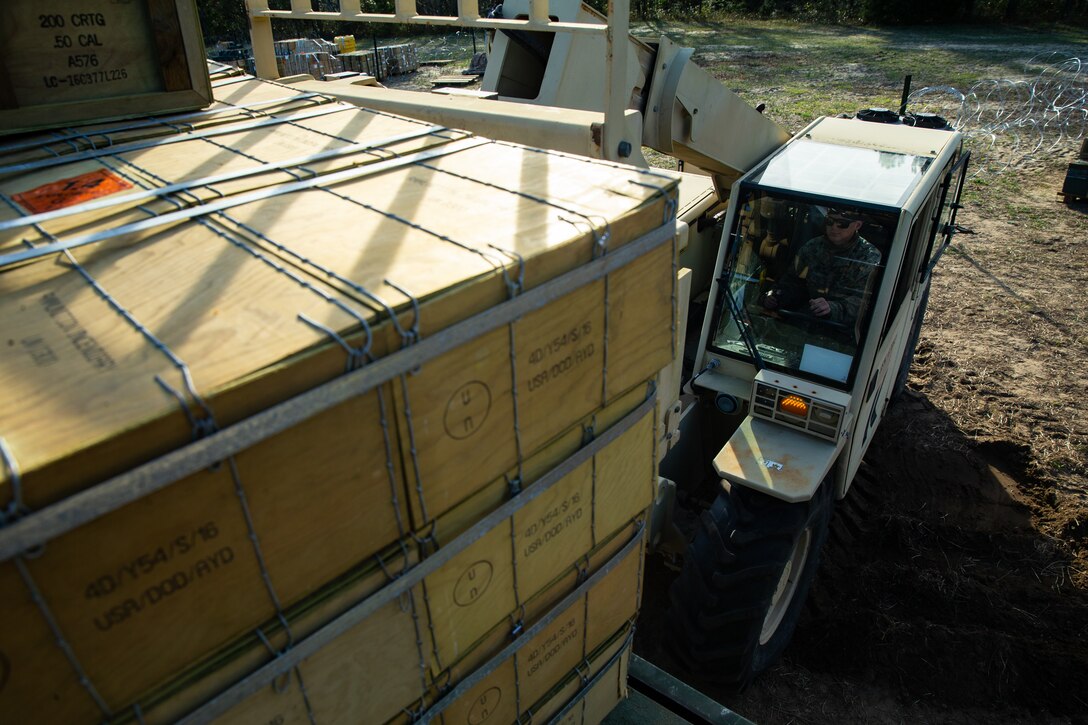 U.S. Marine Lance Cpl. Robert Filichia with Ammunition Company, 2nd Supply Battalion, Combat Logistics Group 25, 2nd Marine Logistics Group operates a light capability rough terrain forklift to load ammunition onto a Medium Tactical Vehicle Replacement on Camp Lejeune, N.C., March 27. 2019. Ammo Co. constructed a Field Ammunition Supply Point in support of 2nd Marine Division to supply everything from 5.56 millimeter small arms to high explosive ordnance. (U.S. Marine Corps photo by Lance Cpl. Damion Hatch Jr.)