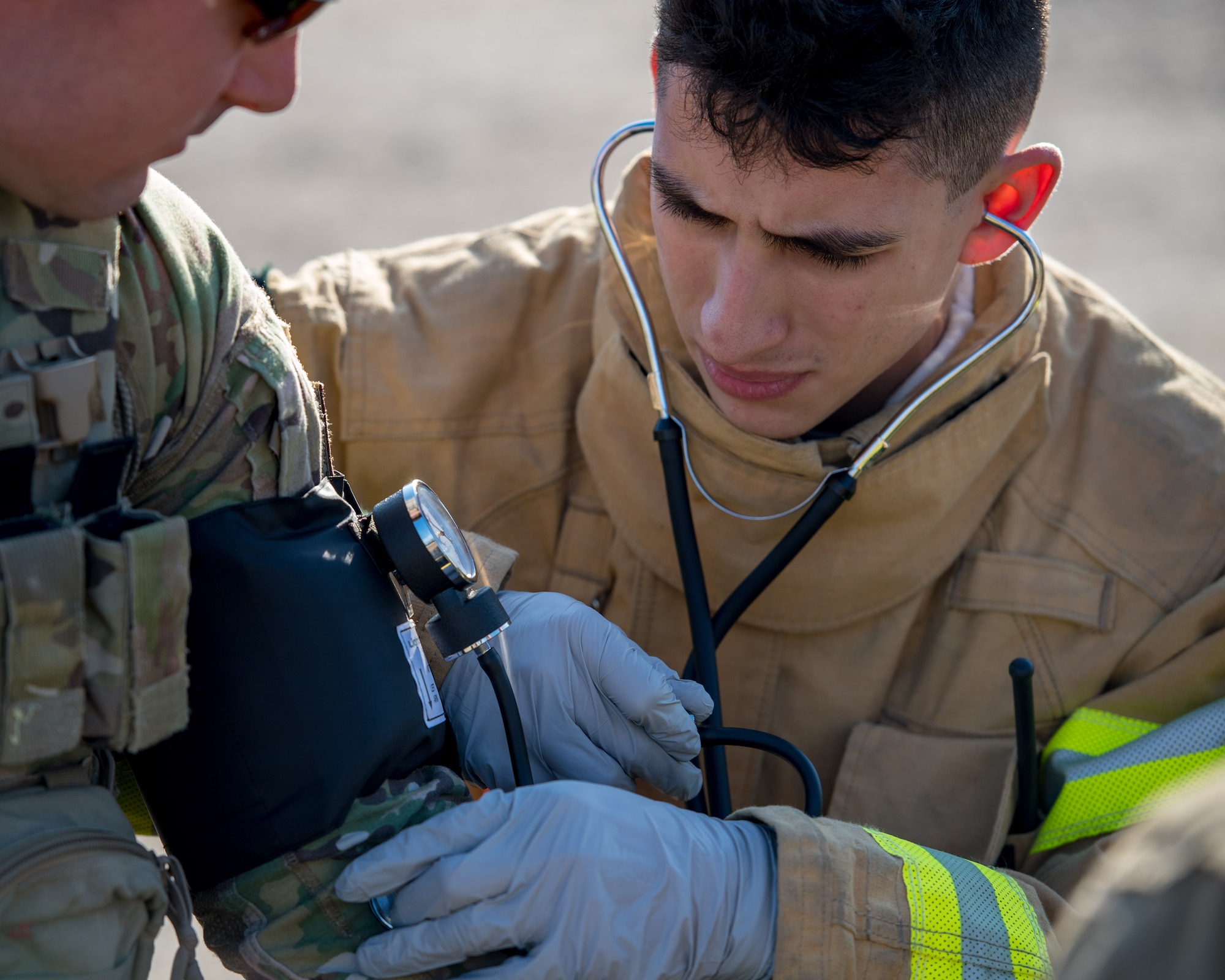 A U.S. Air Force Airman from the 633rd Civil Engineer Squadron fire department check an Airman’s vitals during an active chemical, biological, radiological and nuclear (CBRN) response training at Joint Base Langley-Eustis, Virginia, March 29, 2019.