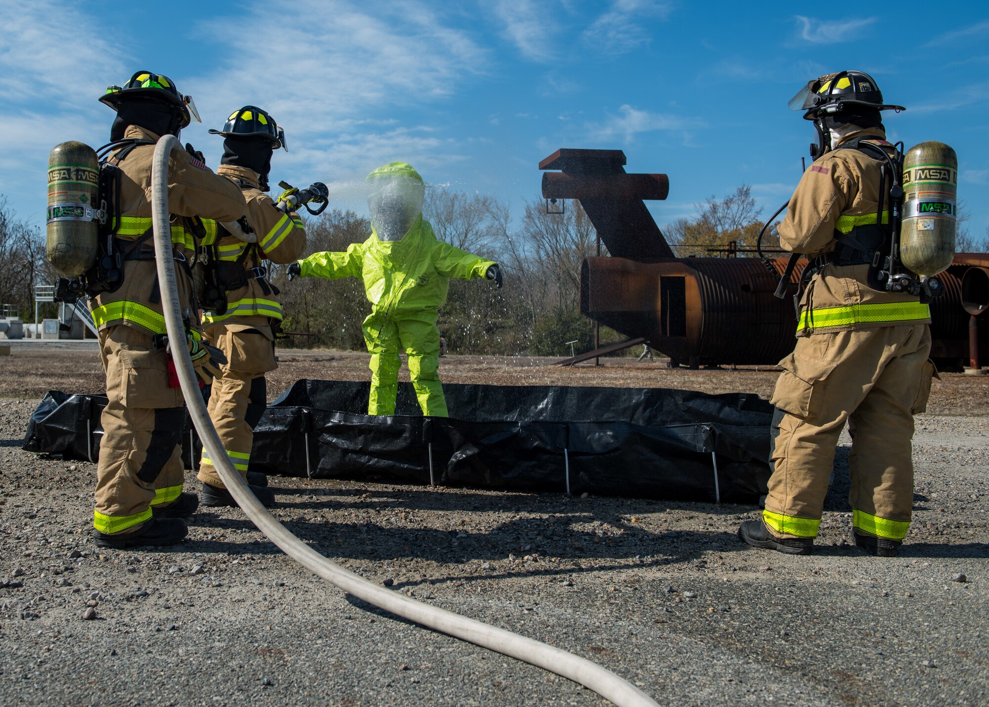 U.S. Air Force Airmen from the 633rd Civil Engineer Squadron decontaminate an Airman from the 633rd Civil Engineer Squadron explosive ordnance disposal during an active chemical, biological, radiological and nuclear (CBRN) response training at Joint Base Langley-Eustis, Virginia, March 29, 2019.