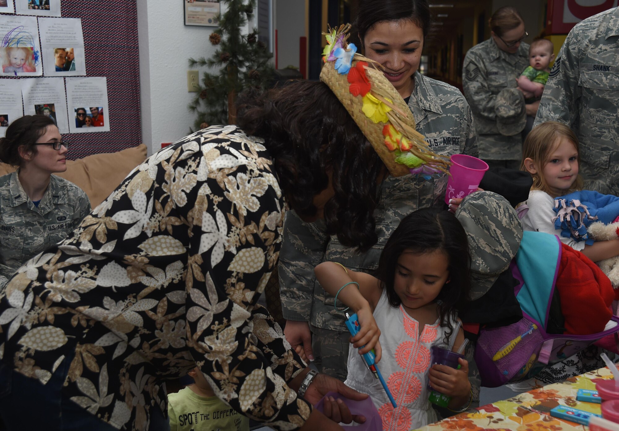 Cecilia Smith, unit sexual assault victim advocate, hands toys and smoothies to kids at Schriever Air Force Base, Colorado, April 14, 2017. The Child Development Center has events planned this month coordinated in partnership with the Sexual Assault Prevention Coordinator office and Airman and Family Readiness for children on the installation in recognition of Month of the Military Child. (U.S. Air Force photo by Senior Airman Arielle Vasquez)