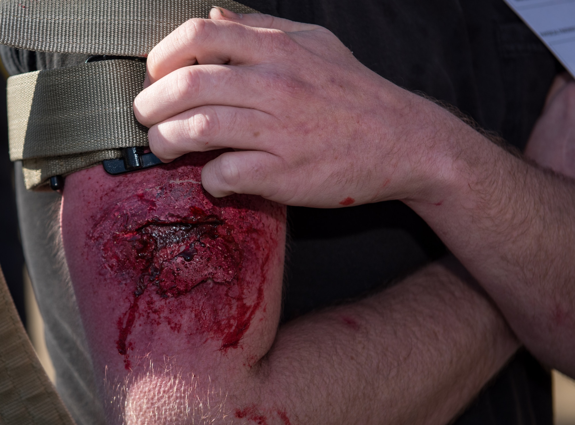 A role-player displays simulated wounds during an active shooter exercise at Langley Air Force Base, Virginia, March 27, 2019.
